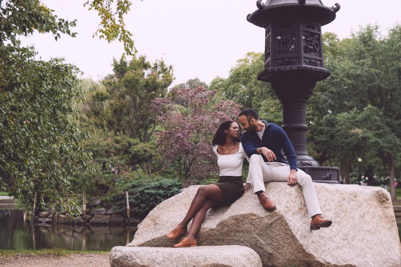 Sheridan and Shail looking at each other while sitting on rocks